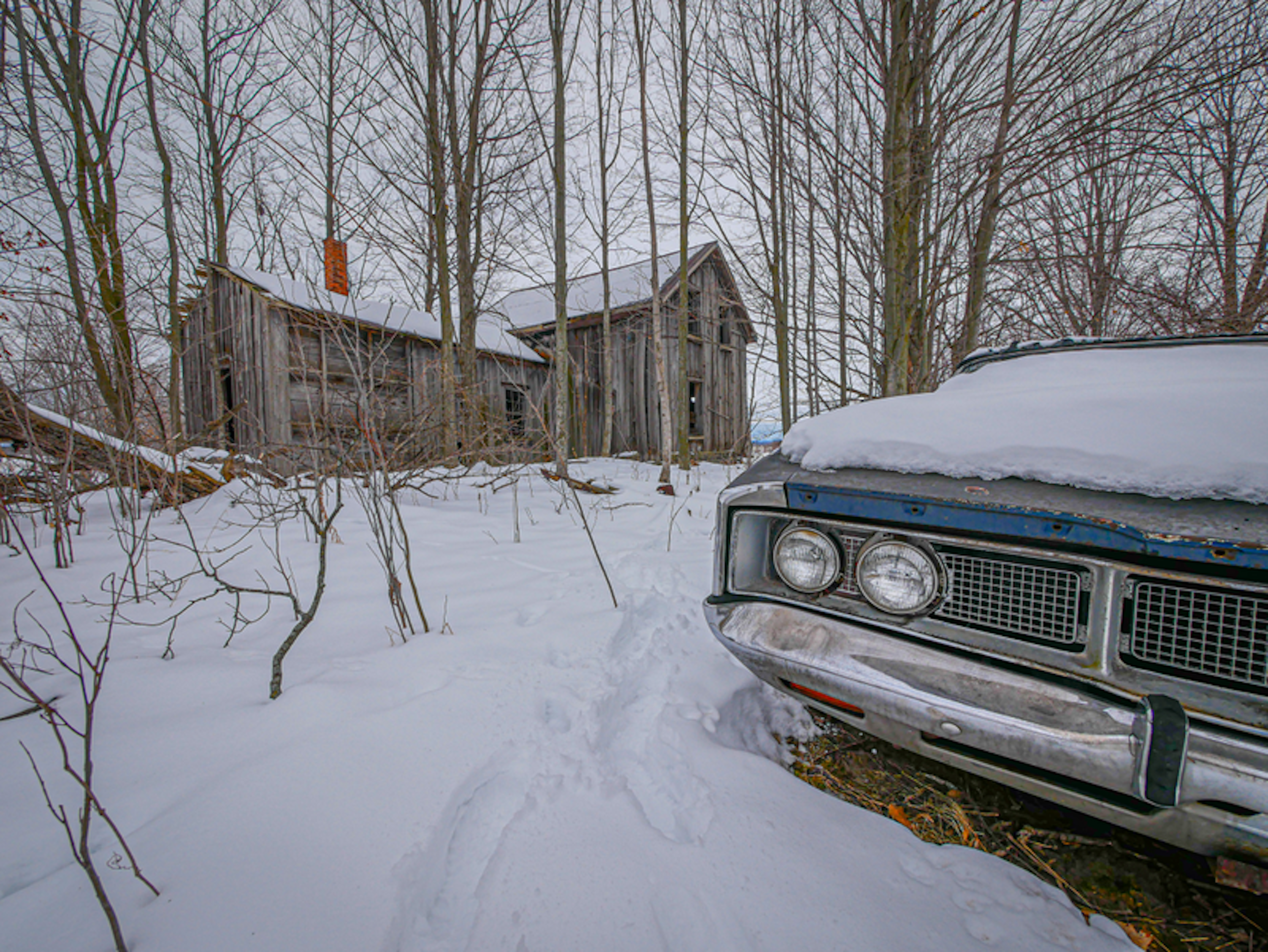 Abandoned Farmhouse with Blue Car